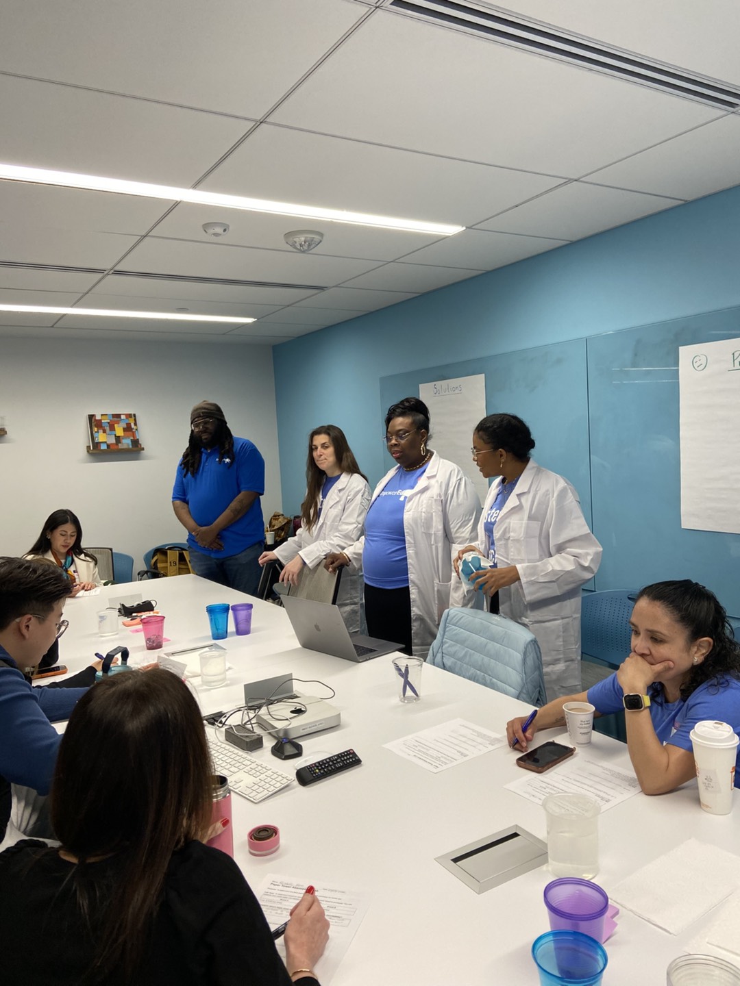 image of people standing around a table
