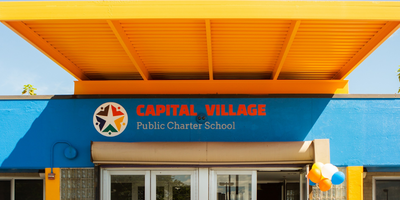 a photograph of the front of the Capital Village PCS school