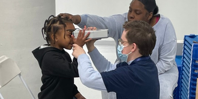 child getting their eyes tested at an eye health event